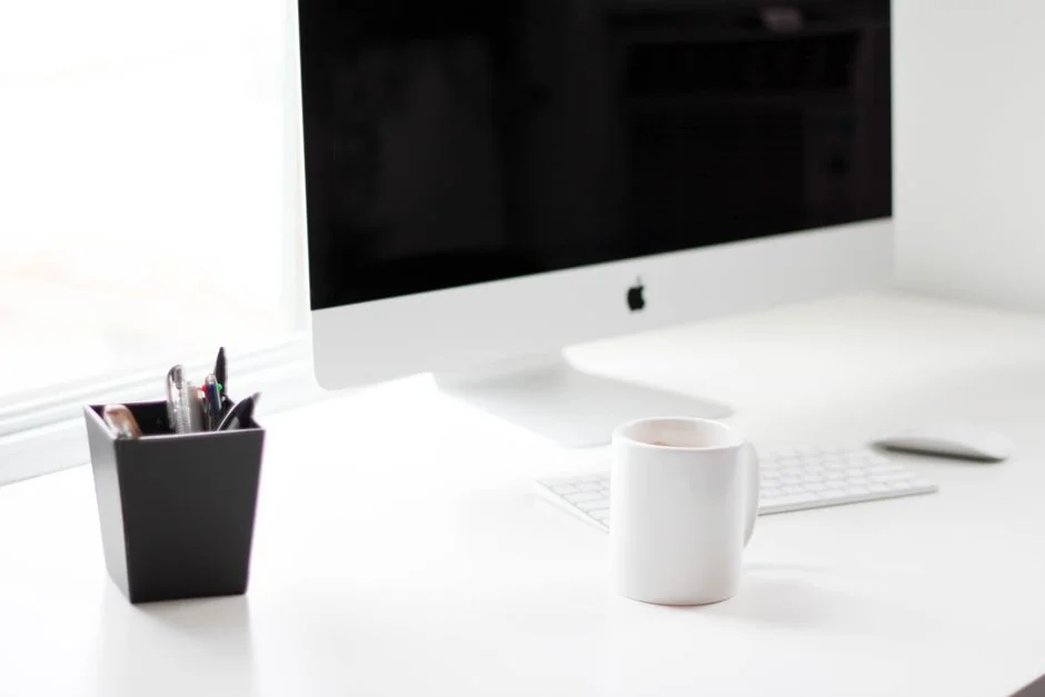 Close-up of an artist designing fashion sketches while seated at a desk indoors.